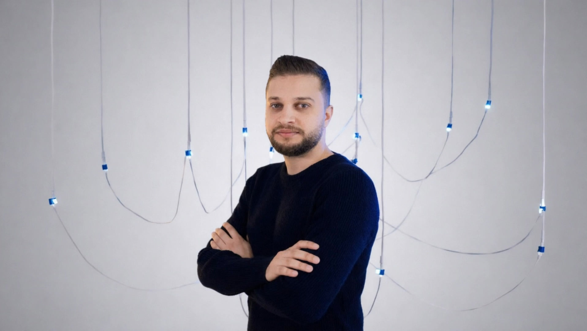 Faris Khaleel, arms crossed, with loose cables around him